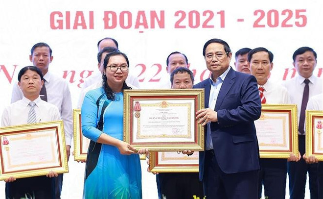 Prime Minister Pham Minh Chinh awards the third-class Labour Order to the Party Committees, administrations and people of the districts with outstanding achievements in the movement "The whole nation joins hands to build new-style rural areas". (Photo: VNA) Prime Minister Pham Minh Chinh awards the third-class Labour Order to the Party Committees, administrations and people of the districts with outstanding achievements in the movement "The whole nation joins hands to build new-style rural areas". (Photo: VNA)
