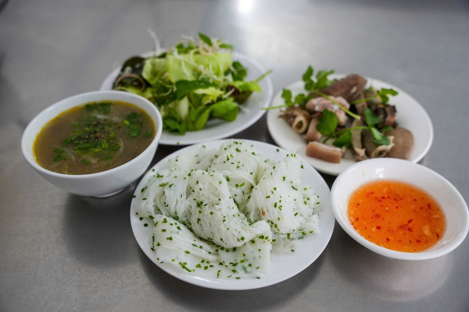 A high-quality batch features strands as thin as bamboo toothpicks, with the portions holding together without breaking or clumping. When eaten, the texture is firm yet tender, revealing the natural sweetness of rice flour and the richness of coconut oil. The dish is typically served with pork offal—including heart, liver, and kidneys—fresh herbs, and tamarind-based fish sauce. (Photo: Khanh Hoa - VNA)
