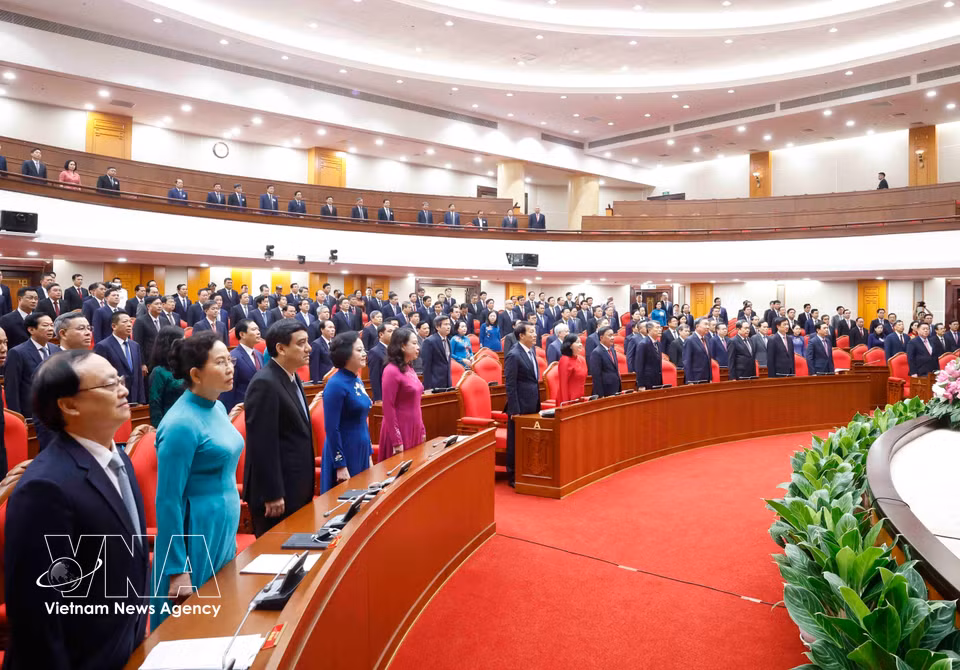 Delegates attend the flag salute ceremony at the closing session of the third meeting of the 14th Party Central Committee. (Photo: Thong Nhat/VNA)