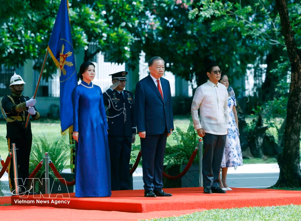 Party General Secretary and State President To Lam and his spouse join President Ferdinand Romualdez Marcos Jr. and First Lady Louise Araneta-Marcos on the podium as the military band plays the national anthems of the two countries. (Photo: Thong Nhat – VNA)