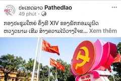 An article on the 14th National Congress of the Communist Party of Vietnam published by the Lao News Agency (Photo: VNA)
