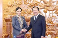 Chairman of the Communist Party of Vietnam (CPV) Central Committee's Commission for Information, Education, and Mass Mobilisation Trinh Van Quyet (right) meets with Standing Vice President of the Lao Front for National Construction Central Committee Inlavan Keobounphanh in Hanoi on December 5. (Photo: VNA)