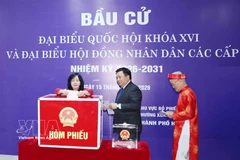 Politburo member and President of the Vietnam Fatherland Front Central Committee Bui Thi Minh Hoai ̣(first, left) casts her ballot alongside other voters at Polling Station No. 7 of Constituency No. 2 in Thanh Xuan ward, Hanoi, on March 15. (Photo: VNA)