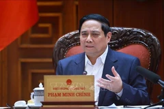 Prime Minister Pham Minh Chinh speaks at the meeting between the Government’s standing members and ministries, sectors and localities on December 16 on preparations for the ground-breaking and inauguration ceremonies for projects celebrating the 14th National Party Congress. (Photo: VNA)