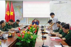 Representatives of relevant units report to Deputy Prime Minister Tran Hong Ha at the meeting. (Photo: VNA)