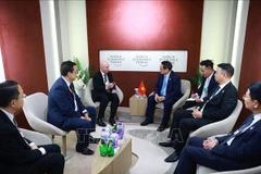 The meeting between PM Pham Minh Chinh and President for Cisco Asia Pacific, Japan, and Greater China (APJC) Dave West in Tianjin on June 25 (Photo: VNA)
