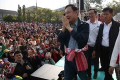 Thailand's former PM Thaksin Shinawatra greets supporters while campaigning in Bueng Kan province on Jan 19. (Photo: Pheu Thai Party) 