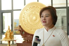 Pham Thi Minh Huong, Chairwoman and General Director of Gold Phuc company, member of the standing board of the General Association of Vietnamese in Laos, speaks to Vietnam News Agency correspondent in Laos ahead the 14th National Party Committee. (Photo: VNA)