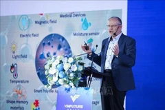 Professor Kurt Kremer, from the Max Planck Institute for Polymer Research in Germany, speaks at the event. (Photo: VNA)