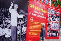 A man visits a Vietnam News Agency-hosted photo exhibition on late President Ho Chi Minh in Hanoi. (Photo: VNA)