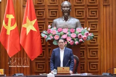 Prime Minister Pham Minh Chinh speaks at the meeting of standing members of the Government on funding sources to support fuel price stabilisation (Photo: VNA)