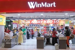 People shop for Tet at a supermarket. (Photo: VNA)