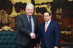 Prime Minister Pham Minh Chinh (R) and Eduard Stiphout, Senior Vice President of ASML, in Hanoi on January 15. (Photo: VNA)