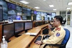 Traffic police officers on duty handling violations through the camera system at the Hanoi Traffic Control Centre. (Photo: VNA)