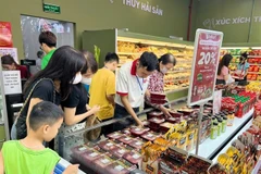 Customers shop for meat products at a supermarket in Hanoi. (Photo: VNA)