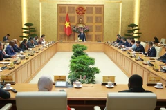 The meeting between Deputy Prime Minister Tran Hong Ha and the delegation of international agriculture ministers and senior officials on July 15 (Photo: VNA)