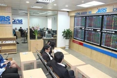 Investors track the market's movements on a trading floor of MB Securities. (Photo: VNA)