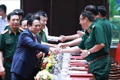 Prime Minister Pham Minh Chinh (front, left) attends the national military-political conference on July 2. (Photo: VNA)