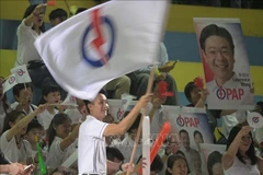 People's Action Party supporters gather to await the results of the general election in Singapore. (Photo: Xinhua/VNA)