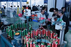 A booth shoiwcasing waving technology at the HanoiTex & HanoiFabric 2025. (Photo: VNA)