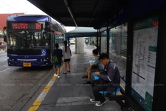 People wait for a bus at a bus stop in Bang Phlat district of Bangkok. (Photo: Bangkok Post/Nutthawat Wichieanbut)