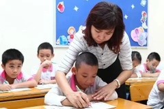 Students from kindergarten to high school in the public school system nationwide will be exempt from tuition fees from the start of the next school year. (Photo: VNA) 