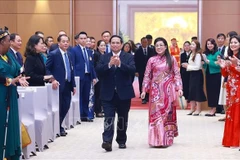 PM Pham Minh Chinh and his spouse at the banquet (Photo: VNA)