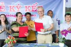 Thi Khui, Director of Bu Lach Organic Cashew Cooperative, signs a cashew purchasing cooperation agreement with a representative of Intersnack Vietnam Cashew Company Limited. (Photo: Dong Nai Newspaper)