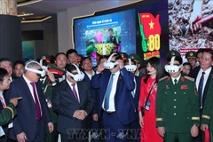 Prime Minister Pham Minh Chinh (second from left) visits the defence product exhibition area of ​​Viettel on December 19. (Photo: VNA)