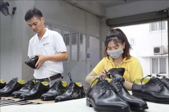 Workers complete the final stages before packaging products at Vien Thinh Shoe Company in Long Hau Industrial Park in Tay Ninh province. (Photo: VNA)