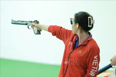 Shooter Trinh Thu Vinh competes in the final of the 10m air pistol mixed team event on December 15 (Photo: VNA)
