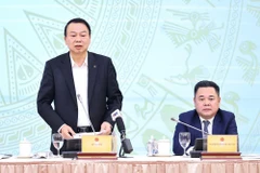 Deputy Minister of Finance Nguyen Duc Chi (standing) addresses the press conference (Photo: VNA)