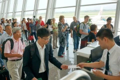 Passengers wait for boarding at an airport. Travel demand is expected to surge during the National Day holiday. (Photo: VNA)
