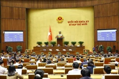 The National Assembly votes to adopt the law amending and supplementing a number of provisions of the Law on Corruption Prevention and Control. (Photo: VNA)