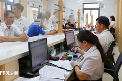 Civil servants process administrative requests at the Public Service Centre of Dong Xoai commune, Dong Nai province. (Photo: VNA)