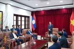 Minister of Public Security Luong Tam Quang visits his ministry's representative office in Laos (Photo: VNA)