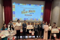 Ambassador Pham Viet Hung, along with representatives of the organising board and jury, honour the award-winning students. (Photo: VNA)