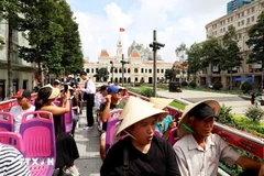 International tourists visit Ho Chi Minh City's downtown area by double-decker bus. (Photo: VNA)