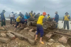 Workers repair the railway sections damaged by the flood. (Photo courtesy of the Vietnm Railways)