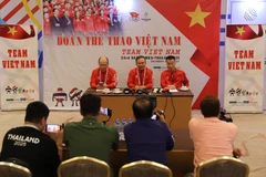Head of the Vietnamese sports delegation Nguyen Hong Minh (centre) and two deputy heads of the delegation preside over the meeting with reporters covering the SEA Games in Bangkok. (Photo: VNA)