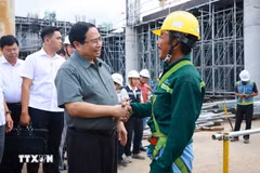 Prime Minister Pham Minh Chinh meets construction workers at the Phu Quoc International Airport project on January 28. (Photo: VNA)
