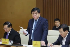 Minister of Planning and Investment Nguyen Chi Dung (centre) speaks at a Government meeting in Hanoi on February 10. (Photo: VNA)