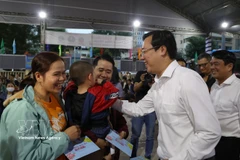 Le Quoc Phong, Permanent Deputy Secretary of the Ho Chi City Party Committee, presents gifts to workers before they get on buses to return to their hometowns on February 12 (Photo: VNA)