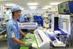 Electronic device manufacturing at the Rhythm Precision Vietnam Co., Ltd., in Hanoi's Noi Bai Industrial Park. (Photo: hanoimoi.vn)