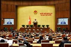Chief Justice of the Supreme People’s Court Nguyen Van Quang presents the draft law. (Photo: VNA)