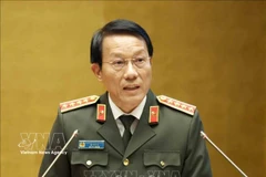 General Luong Tam Quang, Politburo member and Minister of Public Security, speaks at the national conference in Hanoi on February 7. (Photo: VNA)