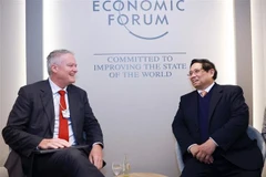 Prime Minister Pham Minh Chinh (L) meets with Secretary-General of the Organisation for Economic Cooperation and Development (OECD) Mathias Cormann in Davos, Switzerland on January 22 (local time) (Photo: VNA)