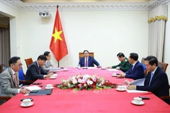 Prime Minister Pham Minh Chinh (C) holds phone talks with his Malaysian counterpart Anwar Ibrahim on December 12, 2025. (Photo: VNA)