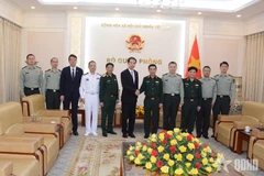 Minister of National Defence Gen. Phan Van Giang (fifth from right), Chinese Ambassador He Wei (sixth from right) and officials at the meeting on April 6 (Photo: qdnd.vn)