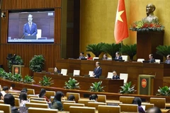 Minister of Education and Training Nguyen Kim Son answers questions raised by legislators. (Photo: VNA)